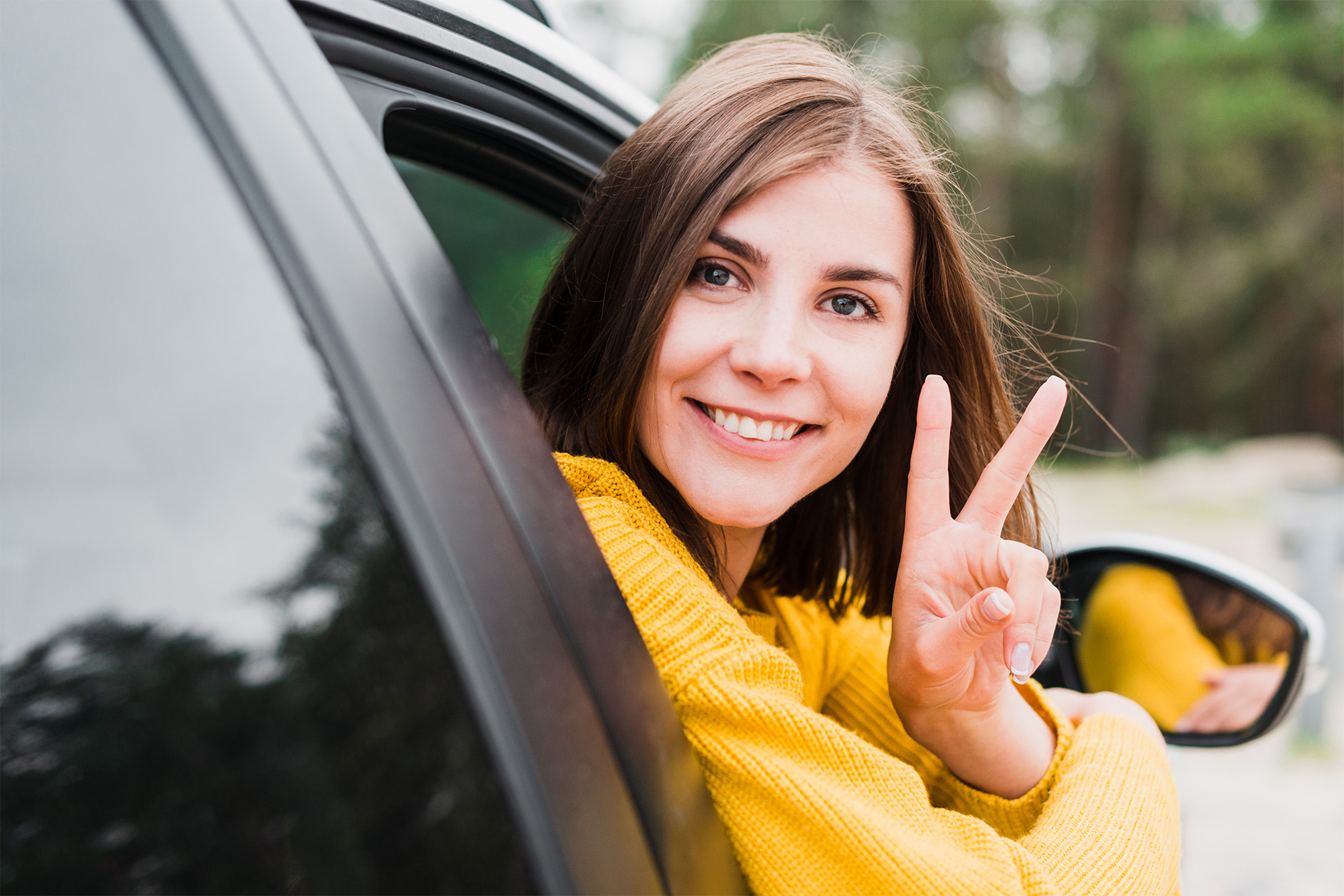 driver leaner waving from his side window